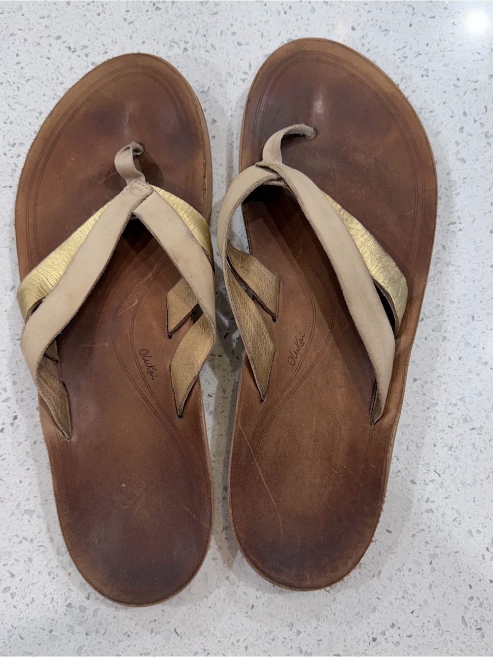 OluKai Brown and Gold Leather Flip Sandals